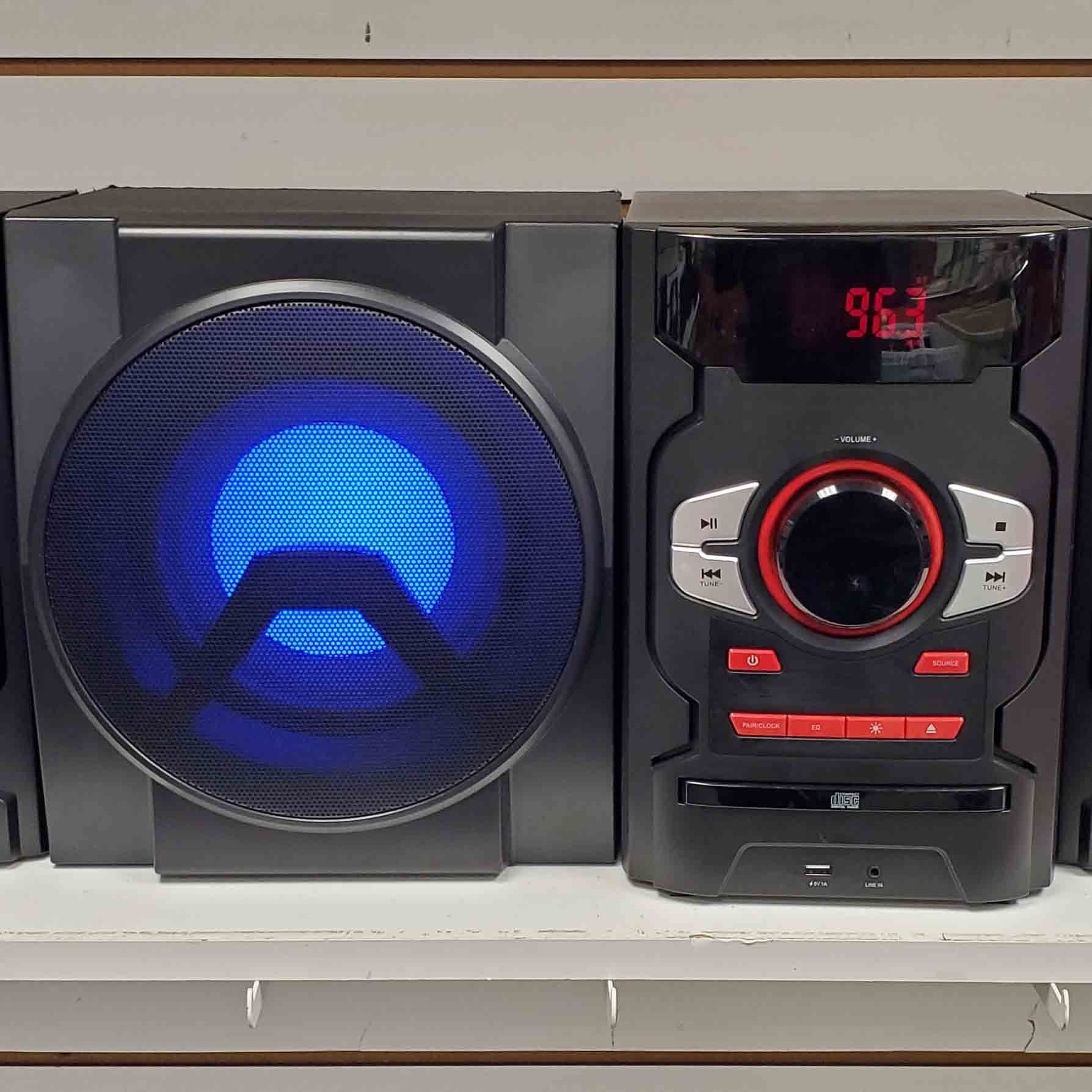 A stereo system is sitting on a shelf with a blue light on it.