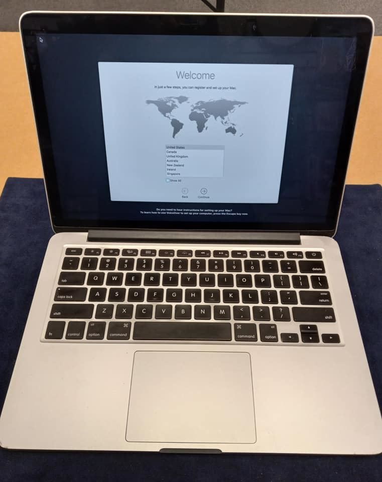A laptop with a welcome screen on the screen