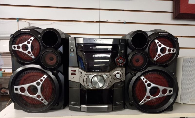 A panasonic stereo system is sitting on a table.