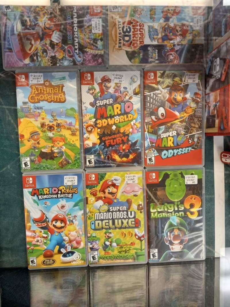 A bunch of video games are sitting on a table.