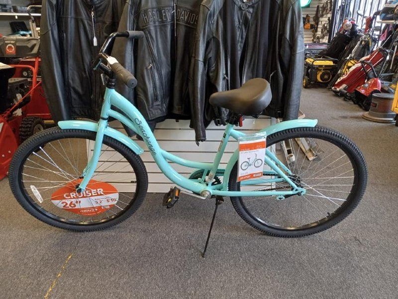 A light blue cruiser bike is for sale in a store