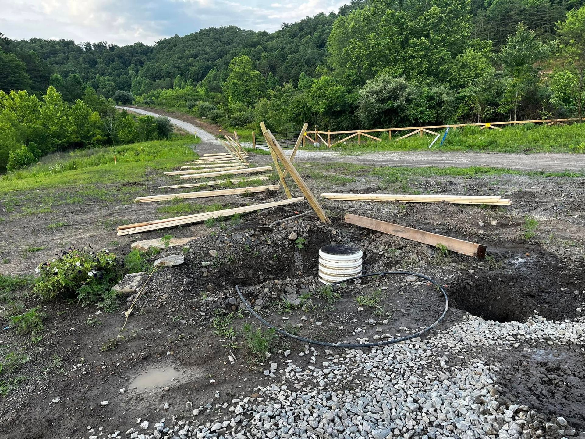 There is a hole in the ground in the middle of a field.