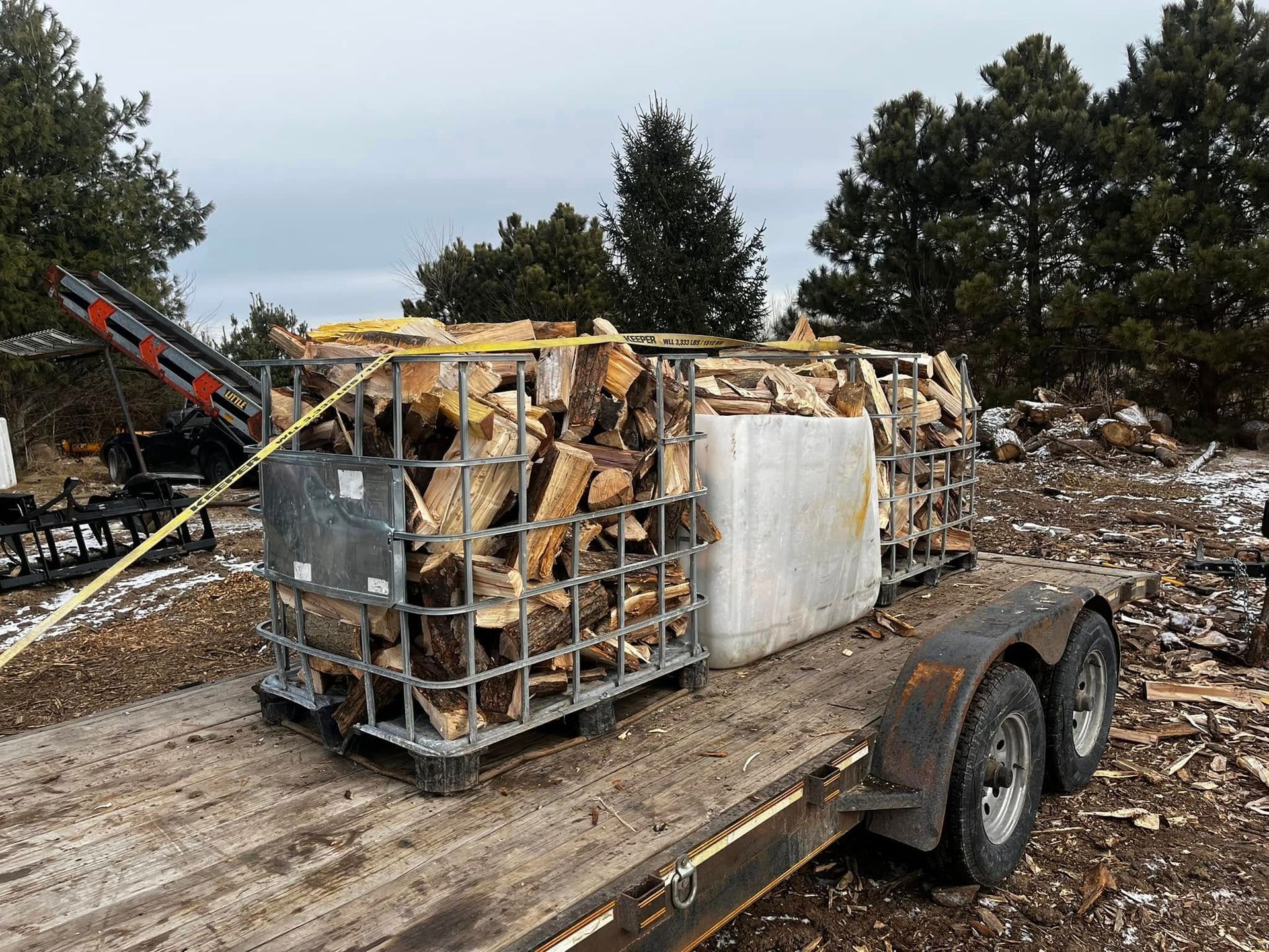 A trailer with a crate of wood on it.