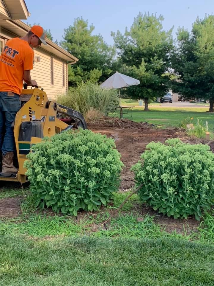 A man is operating a machine in a yard.