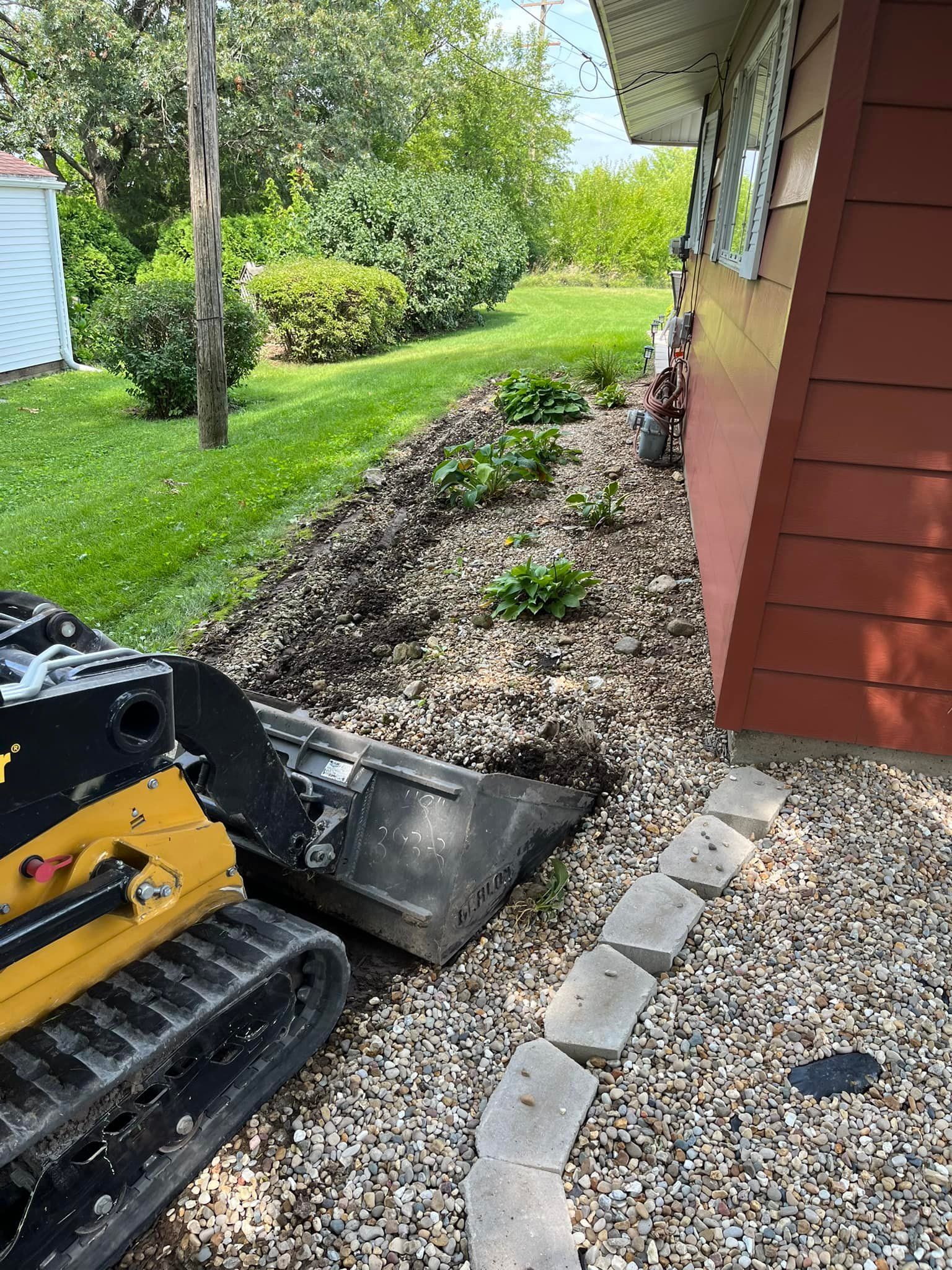 A small bulldozer is parked in front of a house.