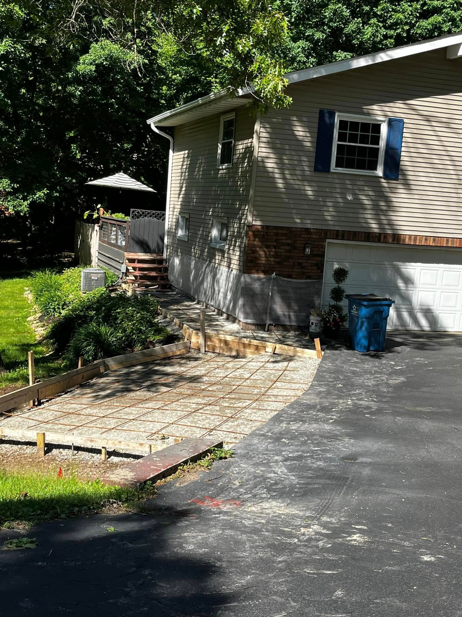 A house with a driveway in front of it is being remodeled.