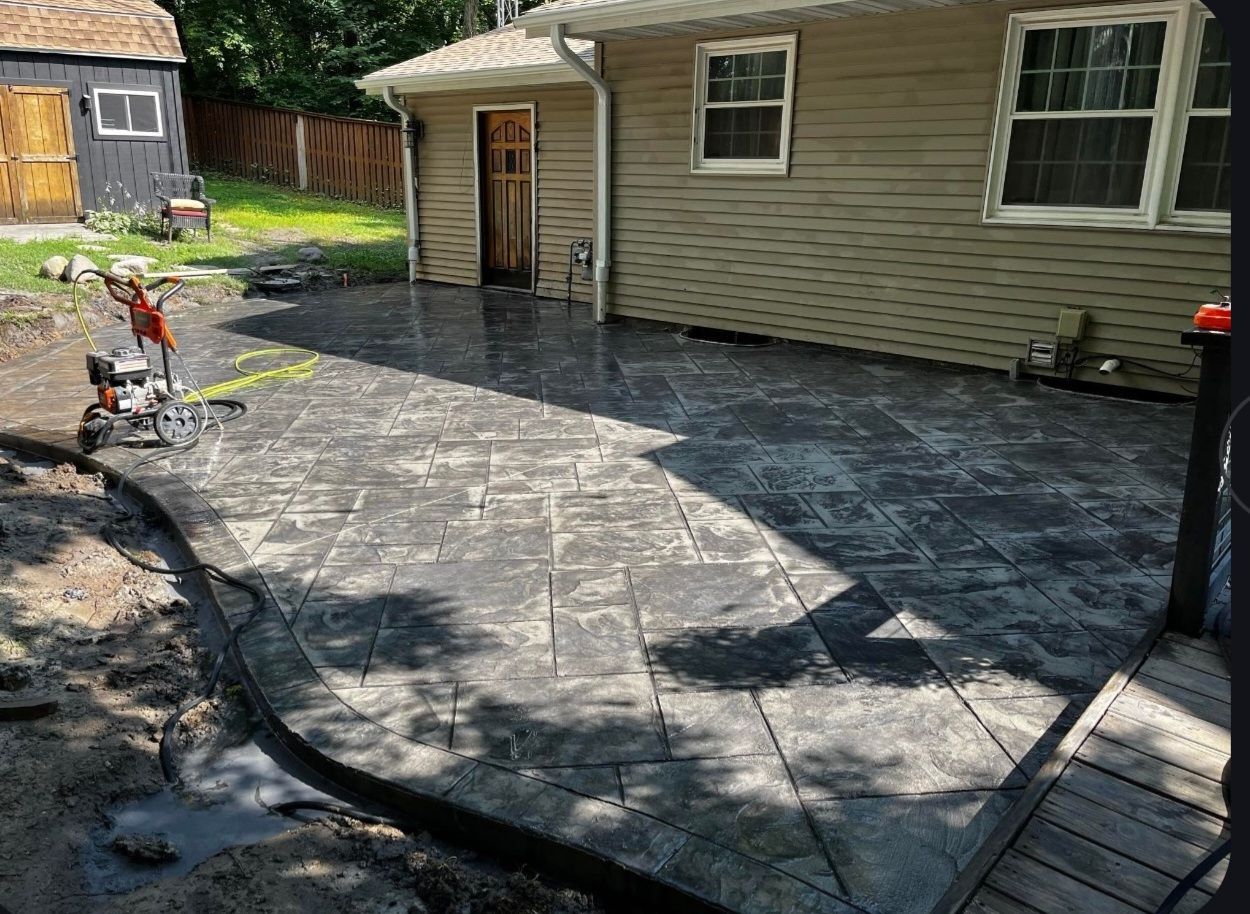 A patio is being built in front of a house.