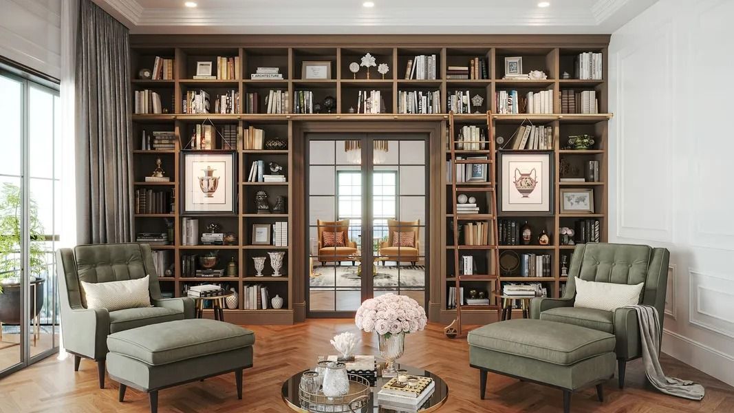 A living room with green armchairs, a large bookshelf, and a circular coffee table with flowers.