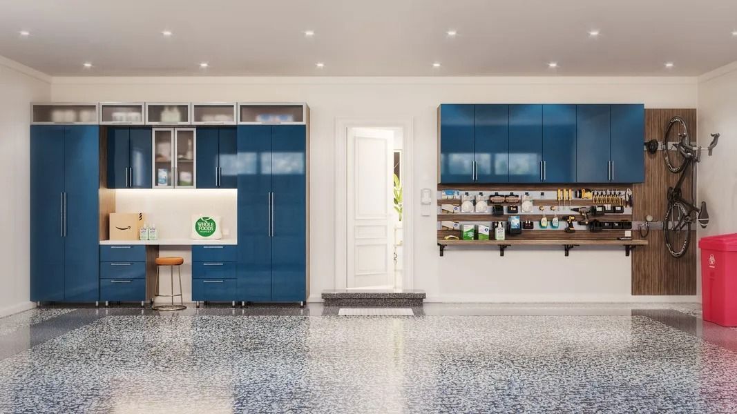 Garage with blue storage cabinets, workbench, bicycle, and red trash can.