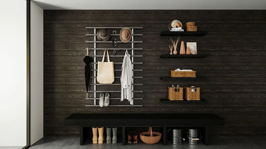 Entryway with coat rack, shelves, bench, and storage against a dark wood wall.