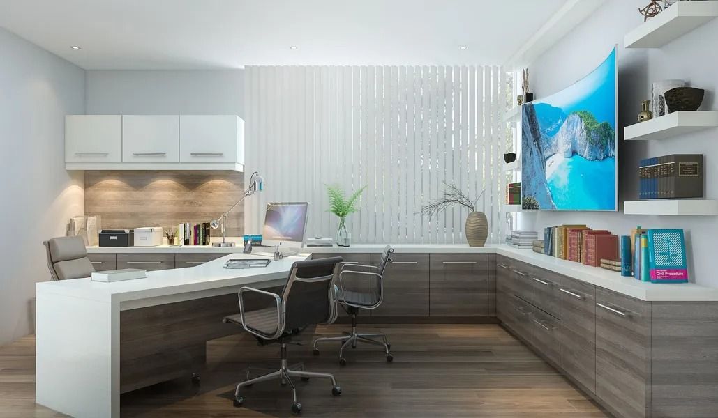 Modern office with desk, chairs, built-in storage, floating shelves with books, and a wall-mounted curved display.