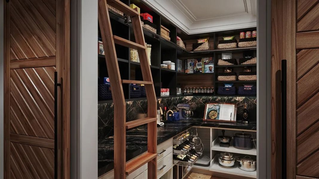 Wooden pantry with ladder, shelves stocked with food, and a black countertop.