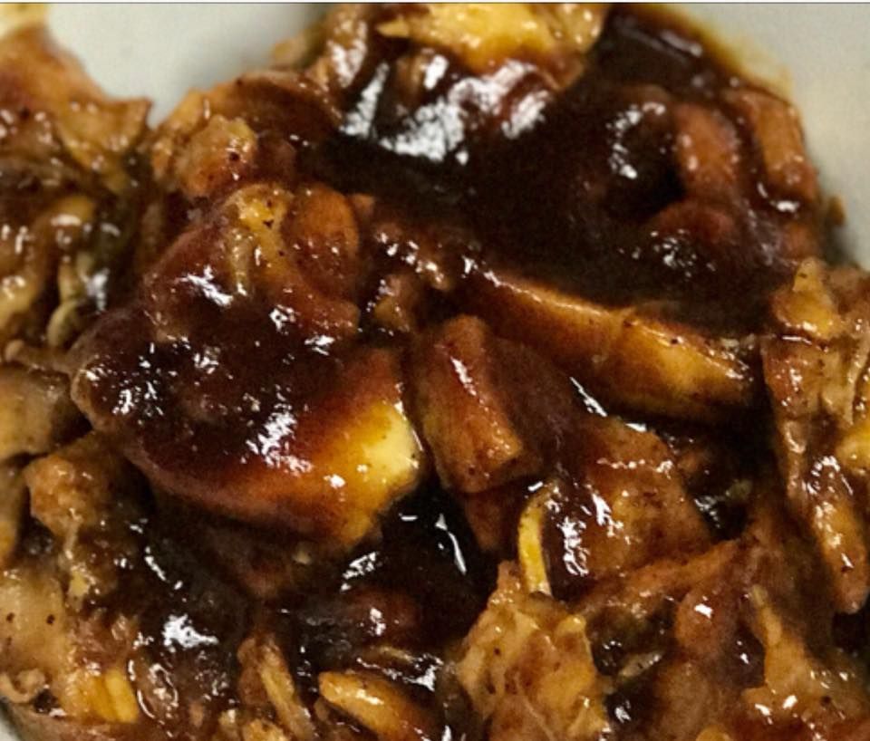 Chicken pieces in a dark, glossy sauce.