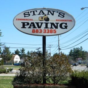 Stan’s Commercial and Residential Paving sign in a landscaped roadside area
