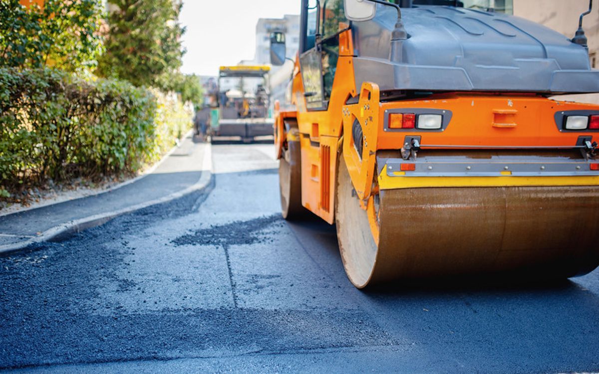 Stan&rsquo;s Paving roadside sign in red, black, and white against a blue sky