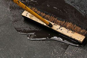 A broom is being used to clean a wet floor.