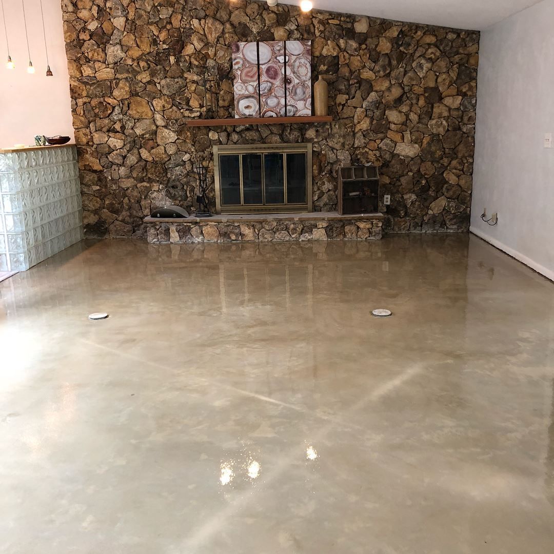 A living room with a fireplace and a stone wall.