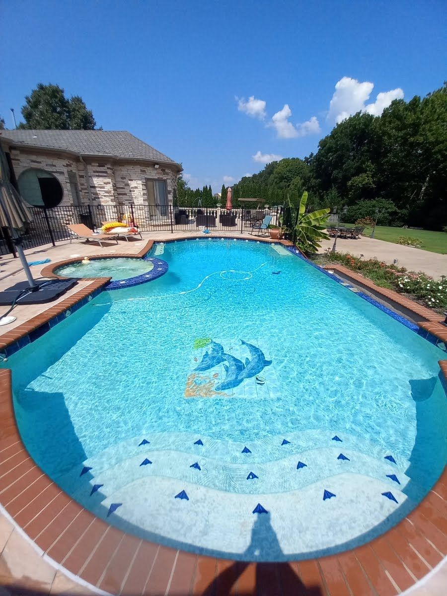A large swimming pool with a dolphin design on the side