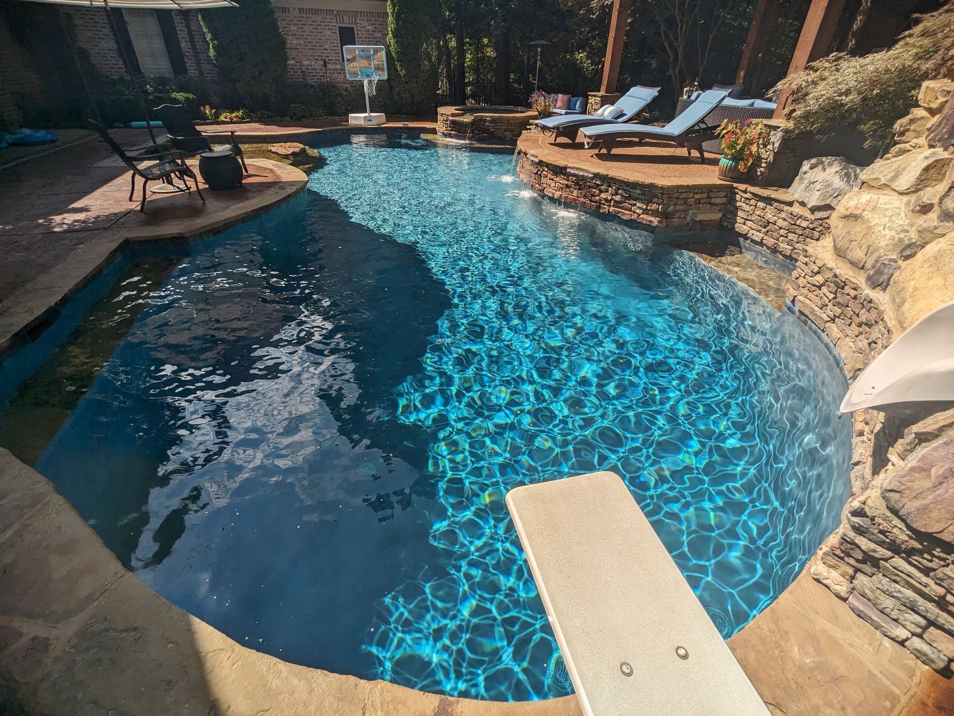 There is a diving board in the middle of the pool.