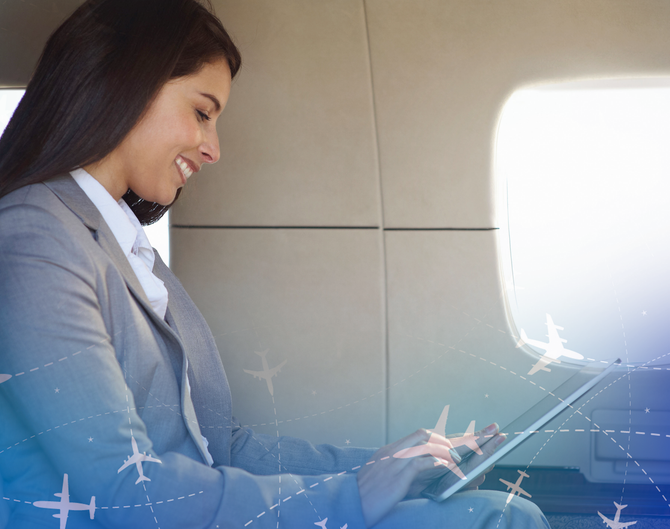 Woman in a suit smiling, using a tablet inside an airplane, with airplane graphics overlaid.
