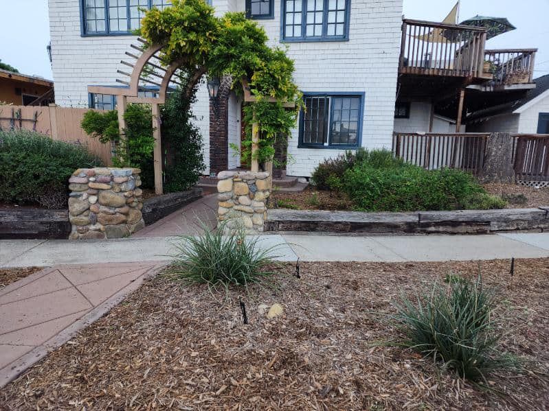 A white house with a stone walkway leading to it