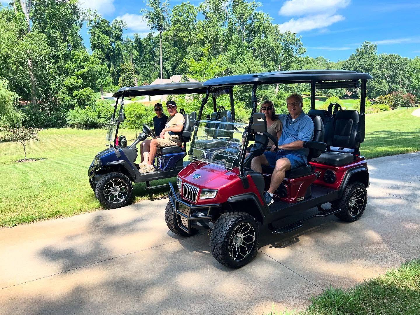 Two golf carts are parked next to each other on a driveway.