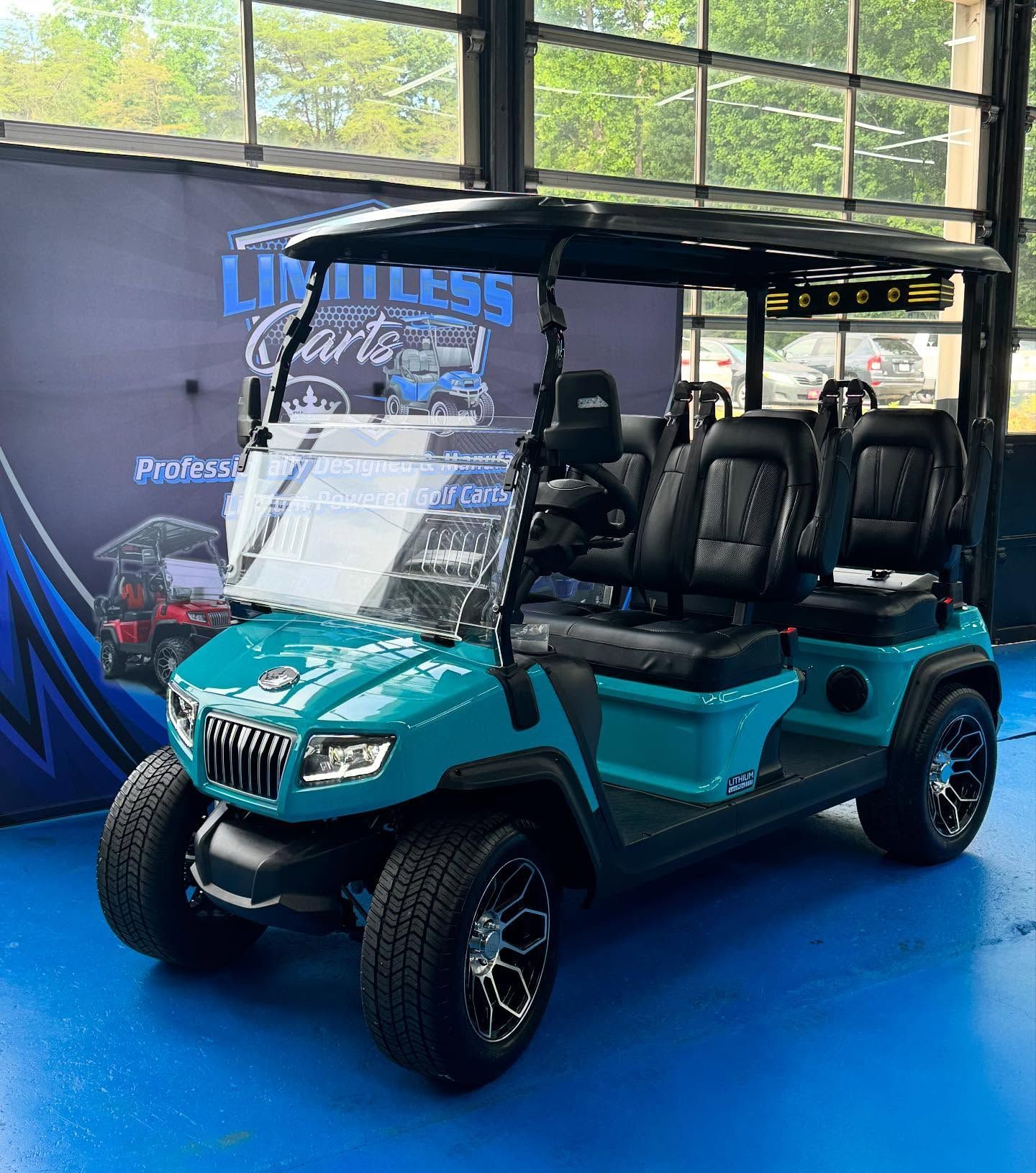 A green golf cart is parked in a garage.
