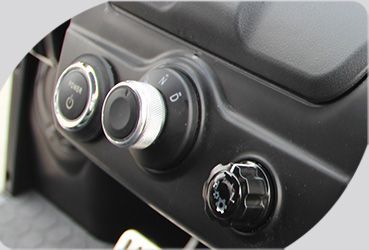 A close up of a car dashboard with a few buttons on it