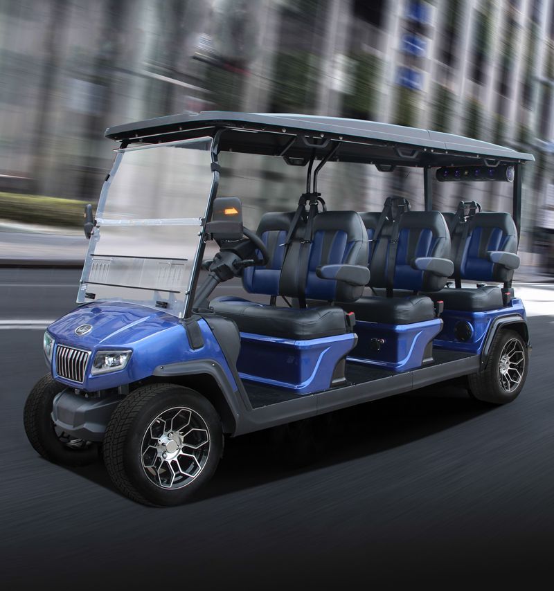 A blue golf cart is driving down a city street.