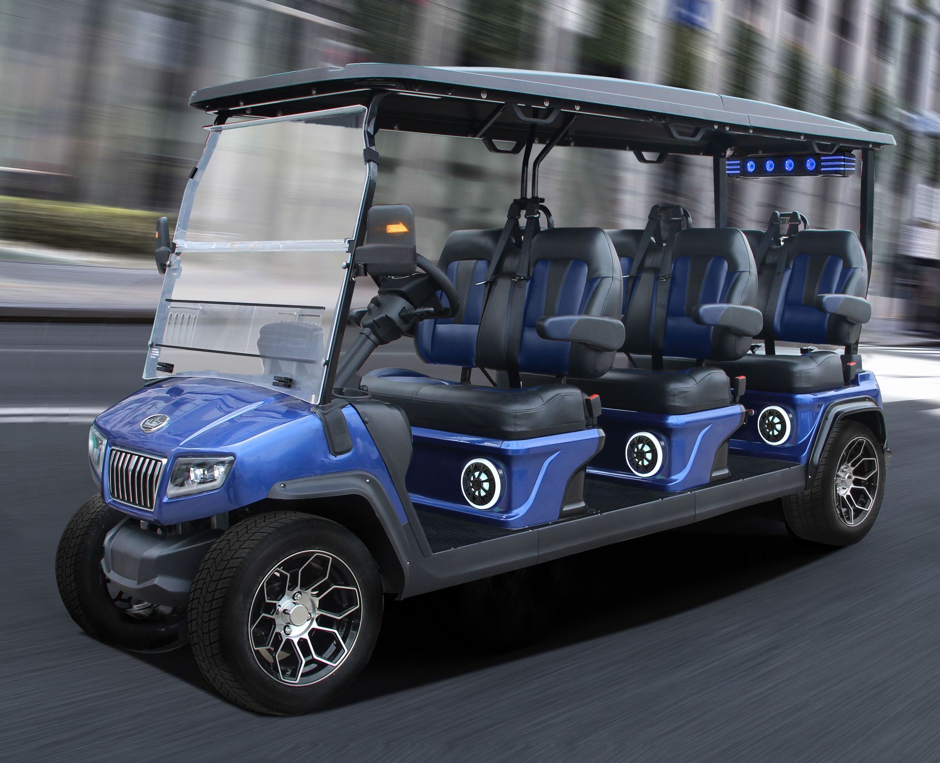 A blue golf cart is driving down a city street.