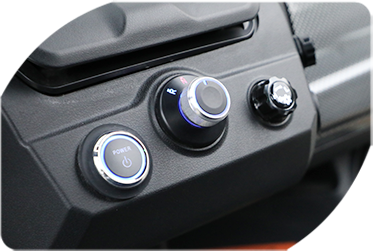 A close-up of a car dashboard with buttons and knobs.