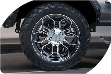 A close-up of a car wheel with a tire on it.