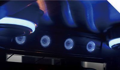 A close up of a ceiling with speakers and lights on it.
