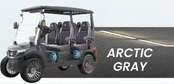 A black golf cart is parked on the side of a road.