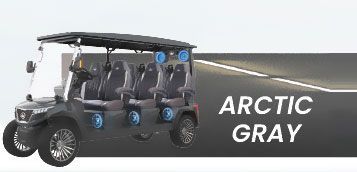 A black golf cart is parked on the side of a road.