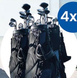 A bunch of golf clubs are stacked on top of each other.