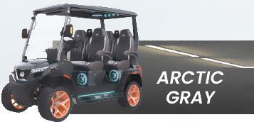 A black golf cart is parked on the side of a road.
