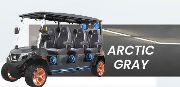 A golf cart is parked on the side of a road in arctic gray.