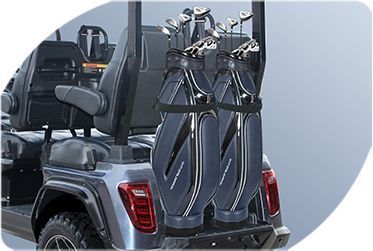 A golf cart with a bunch of golf clubs in the back.