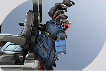 A golf bag is attached to the back of a golf cart.