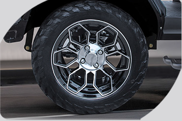 A close up of a car wheel with a tire on it