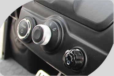 A close up of a car dashboard with buttons and knobs