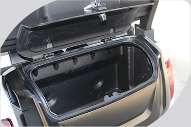 A close up of a motorcycle trunk with the lid open