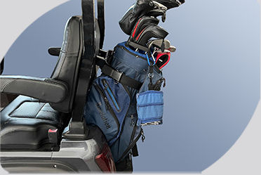 A golf bag is hanging from the back of a golf cart.
