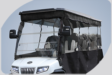 A white golf cart with a clear windshield and a black canopy
