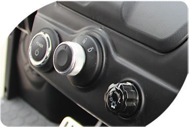 A close-up of a car dashboard with buttons and knobs.