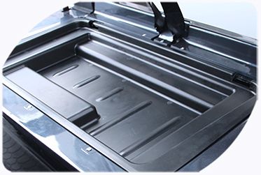 A close up of a storage tray on a golf cart.