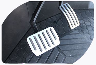 A close up of a golf cart accelerator and brake pedal.
