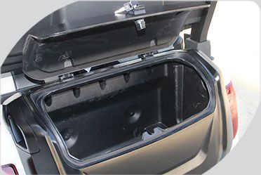 A close up of a motorcycle trunk with the lid open.