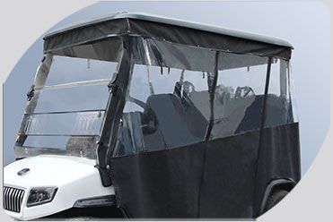 A white golf cart with a clear windshield and a black cover